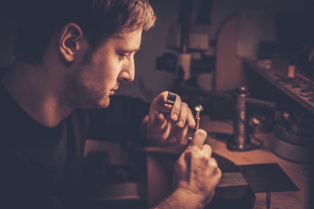 man inspecting hand crafted jewellery