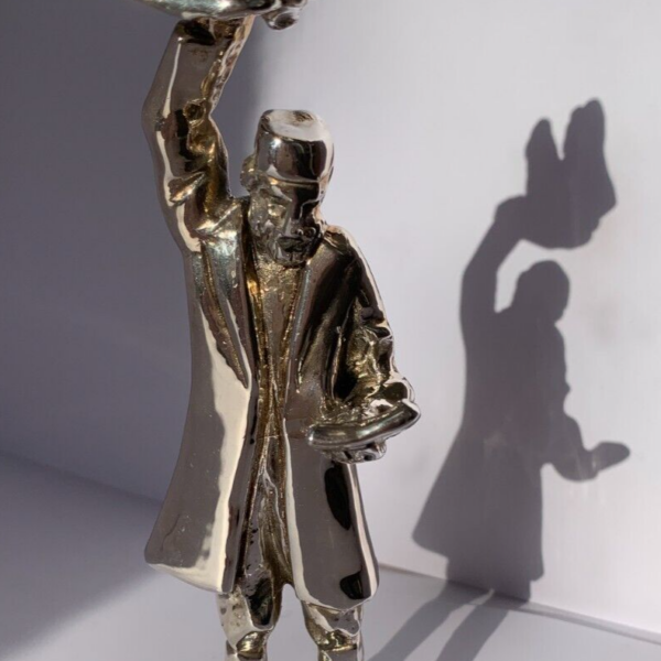 Silver Chassid doing Kapporot with a Chicken Sculpture